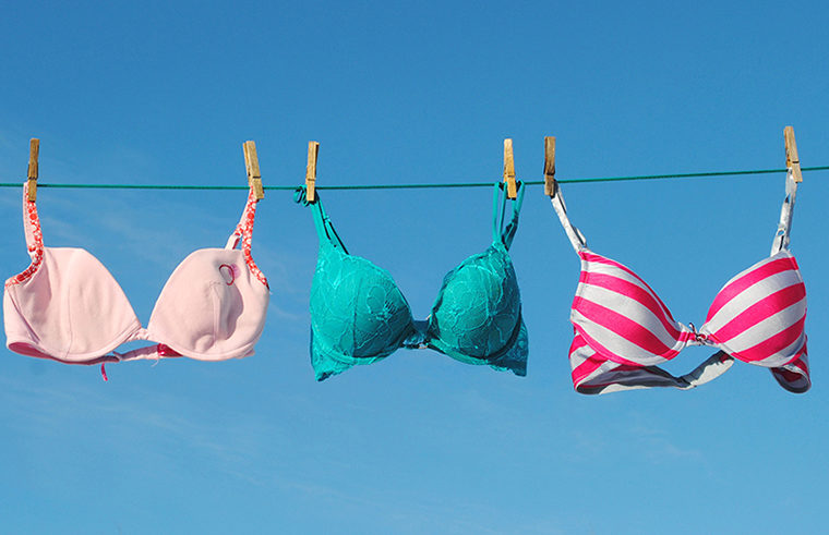 Colourful bras hanging on washing line - feature