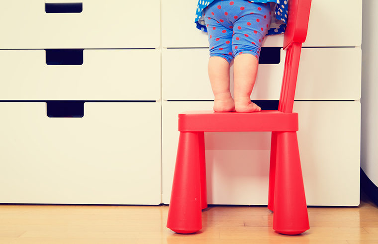 Toddler legs climbing on chair - feature