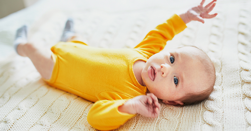 Newborn in yellow onesie