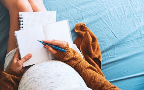 pregnant woman writing