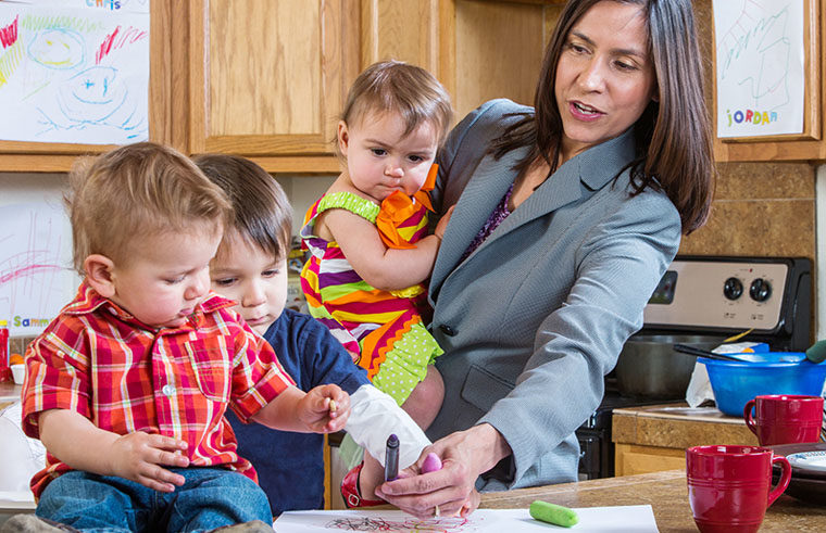 Busy working mother getting three kids ready in morning - feature