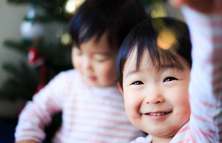 two asian children christmas tree - feature