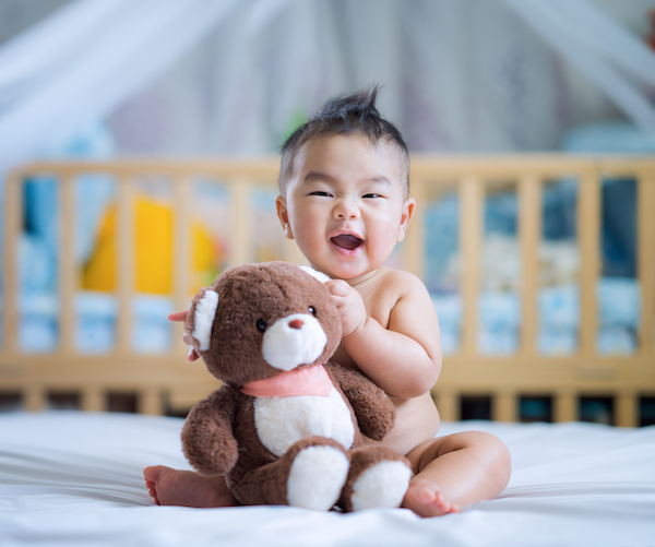 Cute Asian baby with teddy bear