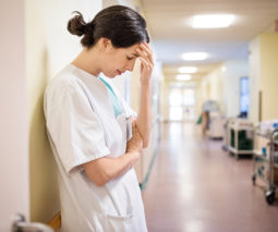 Midwife nurse standing in hospital corridor - feature