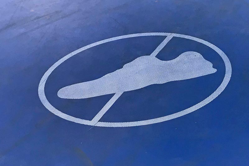 Caravan park no shoes on trampoline sign