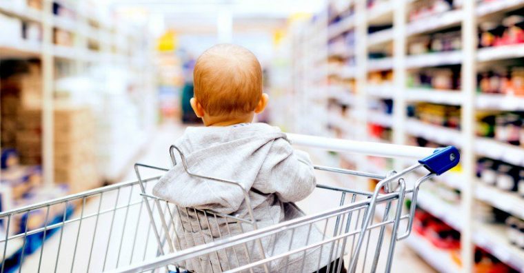 Baby sitting in supermarket trolley