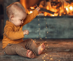 Baby in front of fire feature