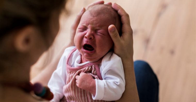 Crying baby in parents hands