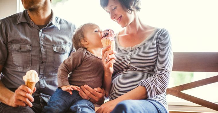 Toddler licking mother's ice cream
