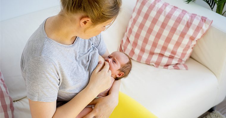 Mother breastfeeding newborn baby