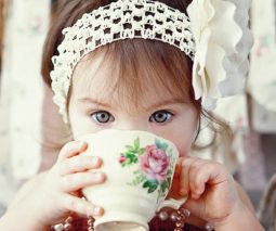 Toddler girl drinking from porcelain cup