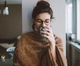 Woman sipping coffee looking peaceful