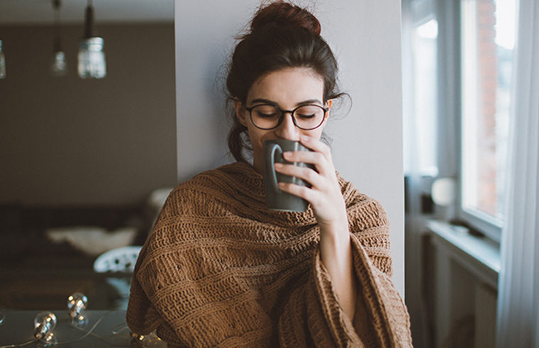 Woman sipping coffee looking peaceful