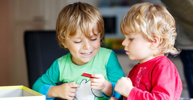 Two preschoolers playing a game together