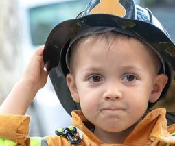 Young boy in fireman's hat and coat