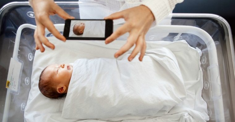 taking photo of newborn baby with smartphone