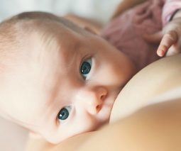 Newborn baby breastfeeding - feature