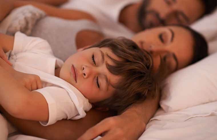 Boy asleep with parents - feature