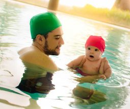 dad and baby swimming