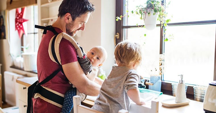 Dad with toddler and baby in carrier