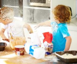 Two children fighting in the kitchen