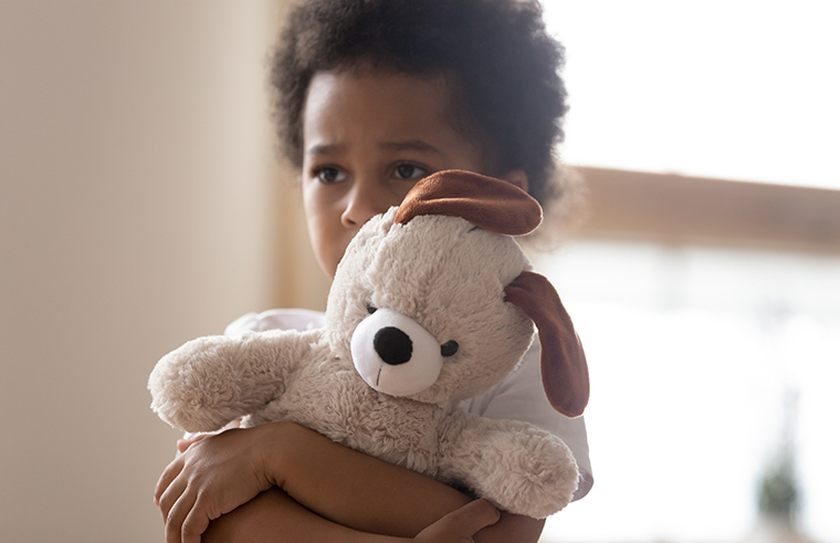 Child and soft toy