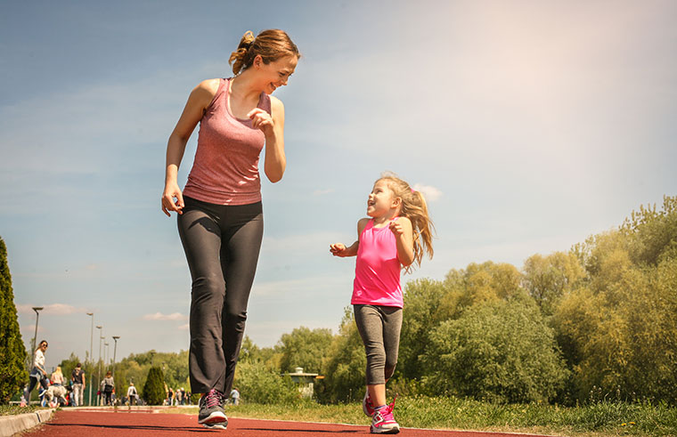 mum and daughter having fun running