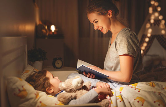mother reading to child at bedtime