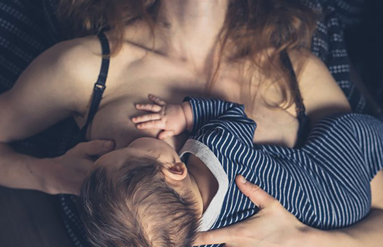 Mother breastfeeding newborn baby - feature