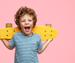Happy kid with yellow skateboard