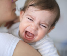 Toddler crying in mothers arms