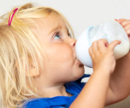 Toddler drinking milk from a sippy cup