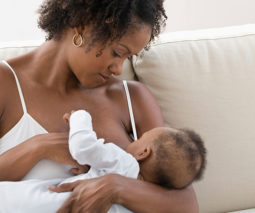 Breastfeeding mother with young baby - feature