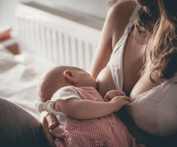 Mother wearing maternity bra breastfeeding baby - feature