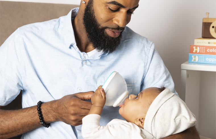 Dad feeding baby with Nanobebe bottle