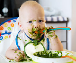 Baby with food all over their face