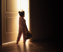 Little girl opening bedroom door during the night