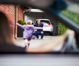 Kid running to dad from car