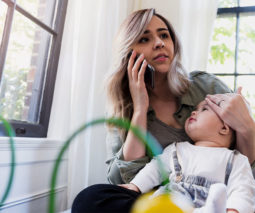 Mum on phone with baby in lap