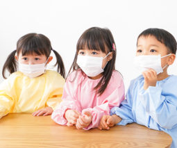 Three kids with face masks on