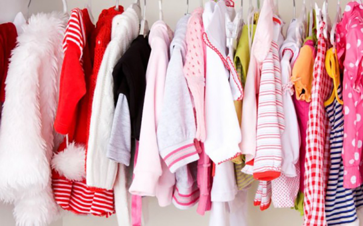 girl's clothes hanging in wardrobe