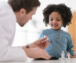 Adult showing a child an Epipen