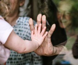 Little girl holding hand out to grandma