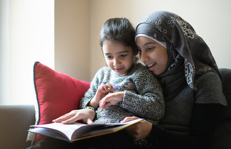 Mother reading with daughter