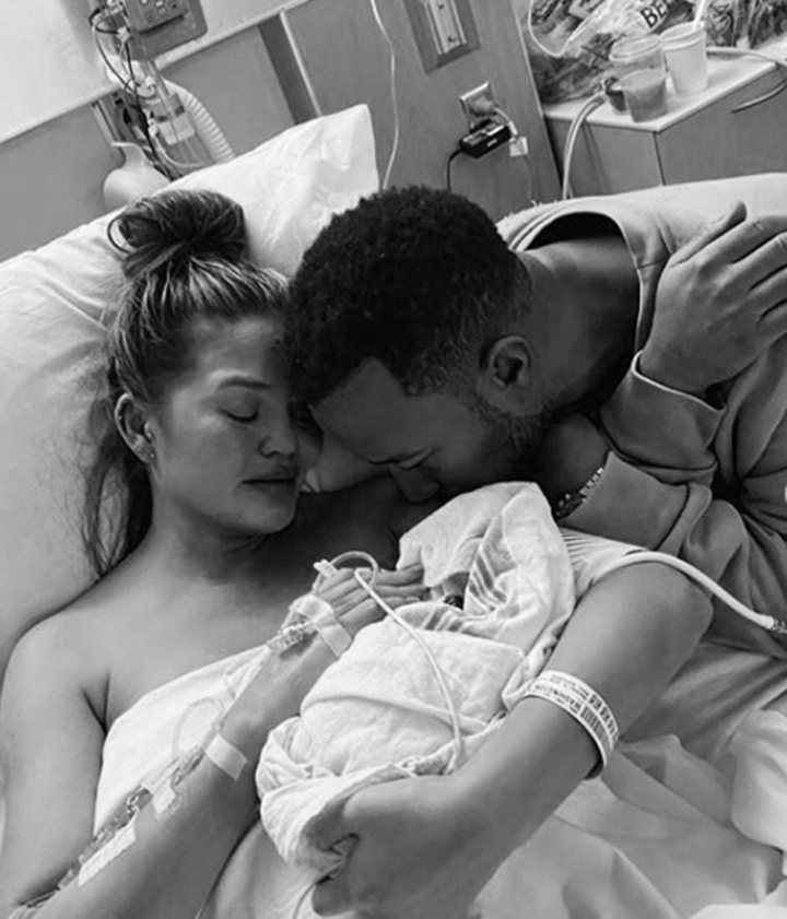 Chrissy Teigen and John Legend holding baby Jack