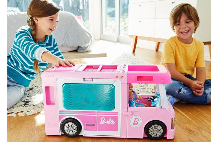 Children playing with Barbie Dream Camper