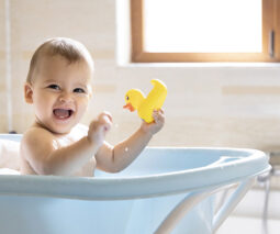 baby in bath with duck
