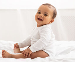 baby smiling on bed