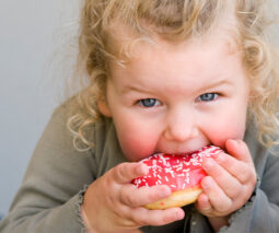 Little girl eating doughnut