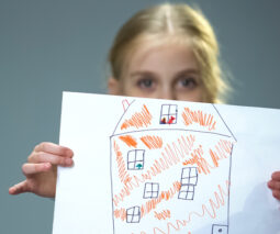 Little girl with picture of house